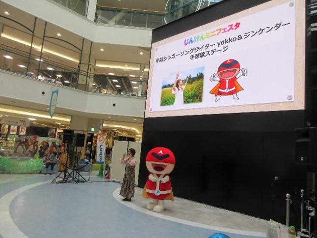 手話シンガーソングライターyokkoさんとジンケンダーの手話ステージの様子