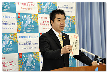 俳句の説明を記者会見で行う様子